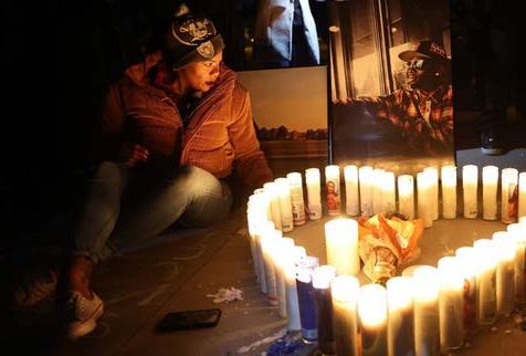 women sitting next to candles in the shape of a heart